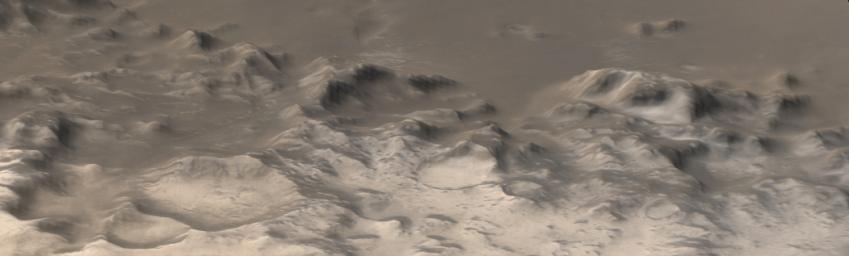 NASA's Mars Global Surveyor shows the Charitum Montes, a mountain range that bounds southern Argyre Planitia. Carbon dioxide frost coats some of the hills, craters, and mountainsides in the southern springtime on Mars.