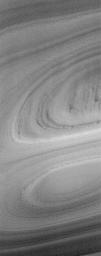 NASA's Mars Global Surveyor shows exposures of Mars' north polar layered material, perhaps composed of a mixture of dust and ice, in the form of a hill and an adjacent depression.