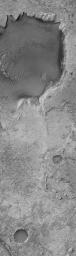 NASA's Mars Global Surveyor shows Sinus Meridiani, the site of the largest outcropping of light-toned, layered sedimentary rocks on Mars. Sedimentary rocks are covered by a regolith of windblown sand and granules.