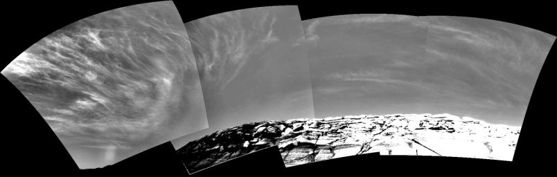 Clouds add drama to the sky above 'Endurance Crater' in this mosaic of frames taken by NASA's Mars Exploration Rover Opportunity on Nov. 16, 2004. The view spans an arc from east on the left to the southwest on the right.