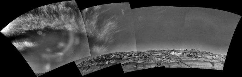 Clouds add drama to the sky above 'Endurance Crater' in this mosaic of frames taken by NASA's Mars Exploration Rover Opportunity on Nov. 17, 2004. The view spans an arc from east on the left to the southwest on the right.