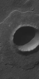 NASA's Mars Global Surveyor shows an impact crater located in Noachis Terra on Mars. The crater's bouldery ejecta blanket has protected underlying material from being eroded away by wind, leaving the ejecta up on a low pedestal.