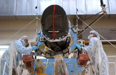 Workers at Lockheed Martin Space Systems, Denver, install a telescopic camera on NASA's Mars Reconnaissance Orbiter spacecraft on Dec. 11, 2004.