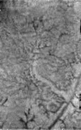 This NASA Huygens Descent Imager/Spectral Radiometer (DISR) instrument image shows two new features on the surface of Titan. A bright linear feature suggests an area where water ice may have been extruded onto the surface.
