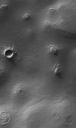 NASA's Mars Global Surveyor shows buttes, craters, and exhuming impact craters in central Argyre Planitia on Mars.