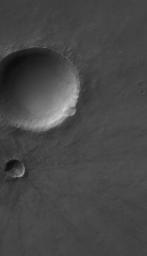 NASA's Mars Global Surveyor shows several meteor impact craters on Solis Planum on Mars. The second-largest crater in this scene is relatively young and fresh, exhibiting arrayed ejecta pattern and numerous boulders near its rim.
