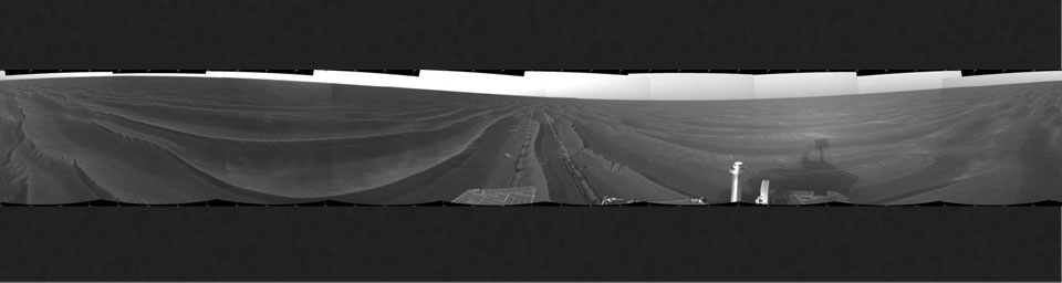 This cylindrical projection shows NASA's Mars Exploration Rover Opportunity's view of its surroundings on Feb. 19, 2005. Opportunity had reached the eastern edge of a small crater dubbed 'Naturaliste,' seen in the right foreground.