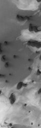 NASA's Mars Global Surveyor shows dark north polar dunes overlying other materials in the north polar region of Mars.