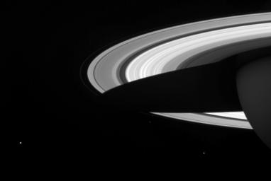 A string of three of Saturn's icy moons encircles the planet in this image captured by NASA's Cassini spacecraft.