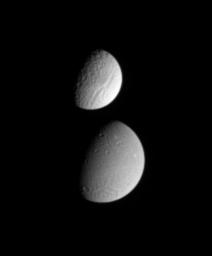 This image from NASA's Cassini spacecraft shows Saturn's moon Tethys partially occulting the moon Dione. The difference in the surface brightness of the two moons is immediately apparent.