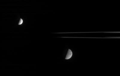 This fanciful view from NASA's Cassini spacecraft spies the Saturnian moons, Dione and Enceladus, from just beneath the ringplane. Enceladus is on the near side of the rings with respect to Cassini, and Dione is on the far side.