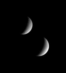 Saturn's sibling moons, Rhea and Dione, pose for NASA's Cassini spacecraft in this view. Even at this distance, it is easy to see that Dione (below) appears to have been geologically active in the more recent past, compared to Rhea (above).
