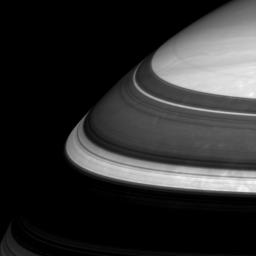 Saturn's rings throw imposing shadows and relegate parts of the planet's northern regions to darkness. Three thin and bright arcs in this scene captured by NASA's Cassini spacecraft represent three well-known gaps in the immense ring system.