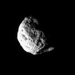 The tumbling and irregularly shaped moon Hyperion rotates away from NASA's Cassini spacecraft in this image taken during a 
distant encounter on Dec. 23, 2005. Hyperion (174 miles across) is covered with closely packed and deeply etched pits.