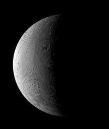 For Enceladus, wrinkles mean the opposite of old age. This view of a crescent Enceladus from NASA's Cassini spacecraft shows a transition zone between a wrinkled and presumably younger region of terrain and an older, more heavily cratered region.