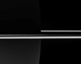 NASA's Cassini spacecraft looked toward the darkened night side of Saturn to capture the eerie glow of the rings, which, not being blocked by the planet's bulk, remained brilliant in full sunlight.