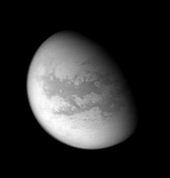 This processed image from NASA's Cassini spacecraft's flyby of Titan reveals mid-latitudes on the moon's Saturn-facing side. Bazaruto Facula is visible with a dark unnamed crater at its center.