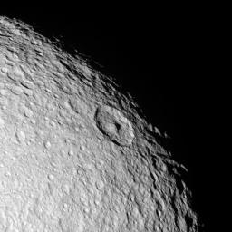 The northern polar region of Saturn's moon Tethys seen in this NASA Cassini flyby image is a ponderously ancient surface. Above the prominent peaked crater Telemachus are the remnants of a very old crater named Teiresias.