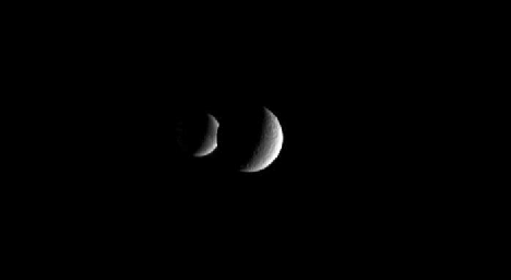 This frame from an animation show two crescent moons dance around Saturn as far-off Dione slips behind its
sibling moon Rhea. NASA's Cassini spacecraft captured this view on Dec. 5, 2005.