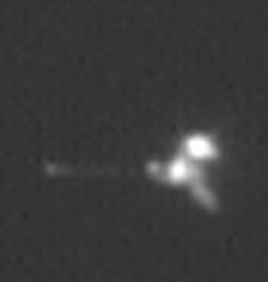This view is an enlargement of an image of NASA's Mars Odyssey spacecraft taken by the Mars Orbiter Camera aboard NASA's Mars Global Surveyor while the two spacecraft were about 90 kilometers (56 miles) apart.