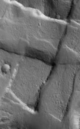 NASA's Mars Global Surveyor shows cross-cutting fault scarps among graben features in northern Tempe Terra. Graben form in regions where the crust of Mars has been extended. Such features are common in the regions surrounding the vast 'Tharsis Bulge.'