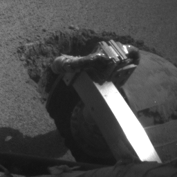 The left rear wheel of NASA's Mars Exploration Rover Opportunity made slow but steady progress through soft dune material in this image taken by the rover's front hazard identification camera over a period of several days.