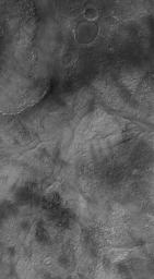 NASA's Mars Global Surveyor shows a valley which has become partially-filled with material. It is located west of Hellas Planitia on Mars. The valley splits to form a 'V.'