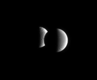 Saturn's moon Dione steps in front of Tethys for a few minutes in an occultation, or mutual event. These events occur frequently for NASA's Cassini spacecraft when it is orbiting close to the ringplane.