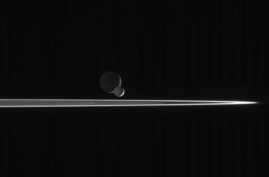 As our robotic emissary to Saturn, NASA's Cassini spacecraft is privileged to behold such fantastic sights as this pairing of two moons beyond the rings. The bright, narrow F ring is the outermost ring structure seen
here.