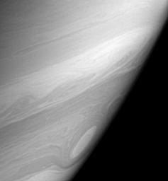 Bright, high altitude clouds, like those imaged here, often appear more filamentary or streak-like than clouds imaged at slightly deeper levels in Saturn's atmosphere. This view from NASA's Cassini also shows one of the many 'cat's eye' vortices.