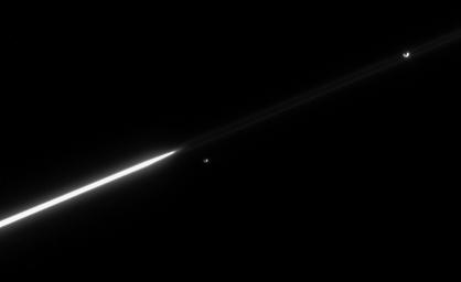 The faint F ring extends across the image; Janus appears directly between its near and far edges taken by NASA's Cassini spacecraft.