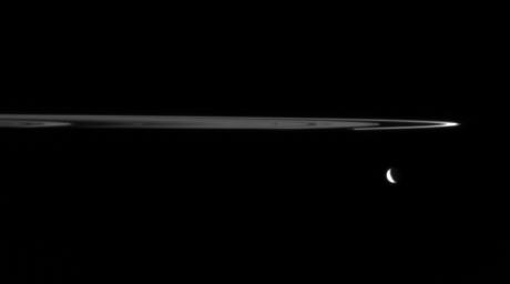 NASA's Cassini finds artistic harmony in the dark and icy realm of Saturn. The dim, unlit side of the rings is shown here. The narrow F ring appears bright when seen from angles near the plane of the rings.