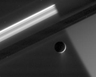 An enhanced close-up view shows at least two distinct jets spraying a mist of fine particles from the south polar region of Enceladus. This image shows the night side of Saturn and the active moon against dark sky as seen by NASA's Cassini spacecraft.