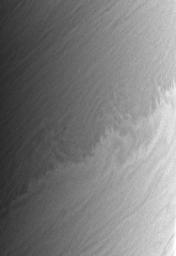 Saturn's restless clouds offer endless complexity, such as this small-scale repeating pattern which is superimposed a larger-scale wavelike modulation of the boundary between a bright zone and a darker belt. This image is from NASA's Cassini spacecraft.