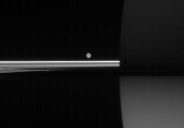 Four minutes after NASA's Cassini spacecraft captured dark Mimas and softly-lit Enceladus near the ringplane, Mimas had slipped into near-obscurity against Saturn's dark side.