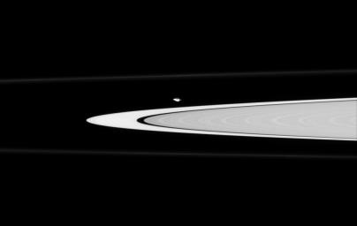 NASA's Cassini spacecraft finds oddly-shaped Atlas gliding along the edge of the A ring. The moon has a prominent equatorial bulge, which is accentuated here by the grazing viewing angle of Cassini, making Atlas appear pointy