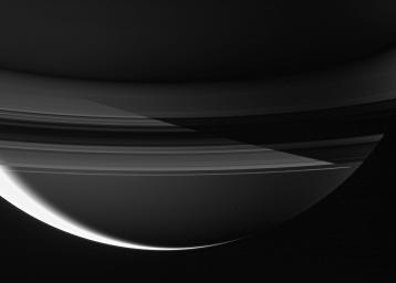 Saturn's shadow cuts sharply across the rings in this remarkable night side view captured by NASA's Cassini spacecraft.