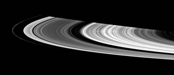 This contrast-enhanced view shows a faint spoke in Saturn's B ring. These ghostly radial structures were imaged by NASA's Voyager spacecraft in the 1980s.