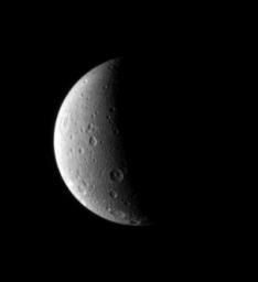 Dione looks lovely half lit in this portrait from NASA's Cassini spacecraft. Just visible is a long canyon running southward just left of the terminator in this image captured by NASA's Cassini spacecraft on Oct. 29, 2006.
