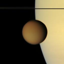The murky orange disk of Saturn's moon Titan glides past -- a silent, floating sphere transiting Saturn. Titan is 5,150 kilometers (3200 miles) across. This view from NASA's Cassini spacecraft was acquired from less than a degree above Saturn's ringplane.