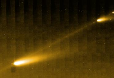 NASA's Spitzer Space Telescope shows three of the many fragments making up Comet 73P/Schwassman-Wachmann 3. The picture also provides the best look yet at the crumbling comet's trail of debris.