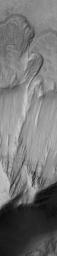 This image from NASA's Mars Global Surveyor shows a landslide that occurred off of a steep slope in Tithonium Chasma, part of the vast Valles Marineris trough system.