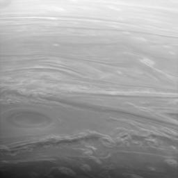 This spectacular image from NASA's Cassini spacecraft of Saturn's clouds looks obliquely across the high northern latitudes. The Sun is low on the horizon here, making the vertical extent of the clouds easier to see. Cloud bands surrounding the vortex,