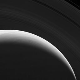 NASA's Cassini spacecraft gazes down at the marvelous rings and swirling clouds of giant Saturn from above the planet's north pole.