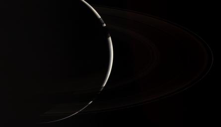 Only NASA's Cassini spacecraft could provide this enchanting, natural color view of crescent Saturn, which gazes down onto the unlit side of the planet's spectacular rings.