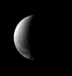 The fractured terrain so distinctive to Dione curves away toward the south in this view, which looks down at the moon's northern hemisphere. This image was captured by NASA's Cassini spacecraft on Nov. 22, 2006.