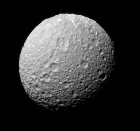 This monochrome view of Saturn's moon Mimas shows color variation across the moon's surface as seen by NASA's Cassini spacecraft.