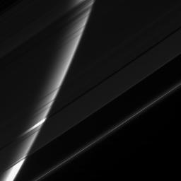 NASA's Cassini spacecraft stares toward Saturn through its gauzy veil of rings. The great ice-particle screen acts like a filter here, attenuating the glare from the planet and making its high altitude haze easy to see.