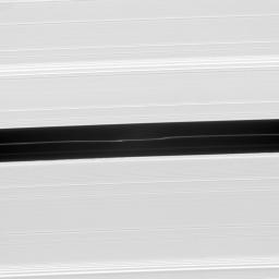 Bright undulations disturb a faint ringlet drifting through the center of the Encke Gap. This ring structure shares the orbit of the moon Pan as seen by NASA's Cassini spacecraft.