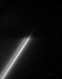 The strands of Saturn's F ring disappear into the darkness of the planet's shadow. Background stars make trails across the sky during the long exposure as seen by NASA's Cassini spacecraft.
